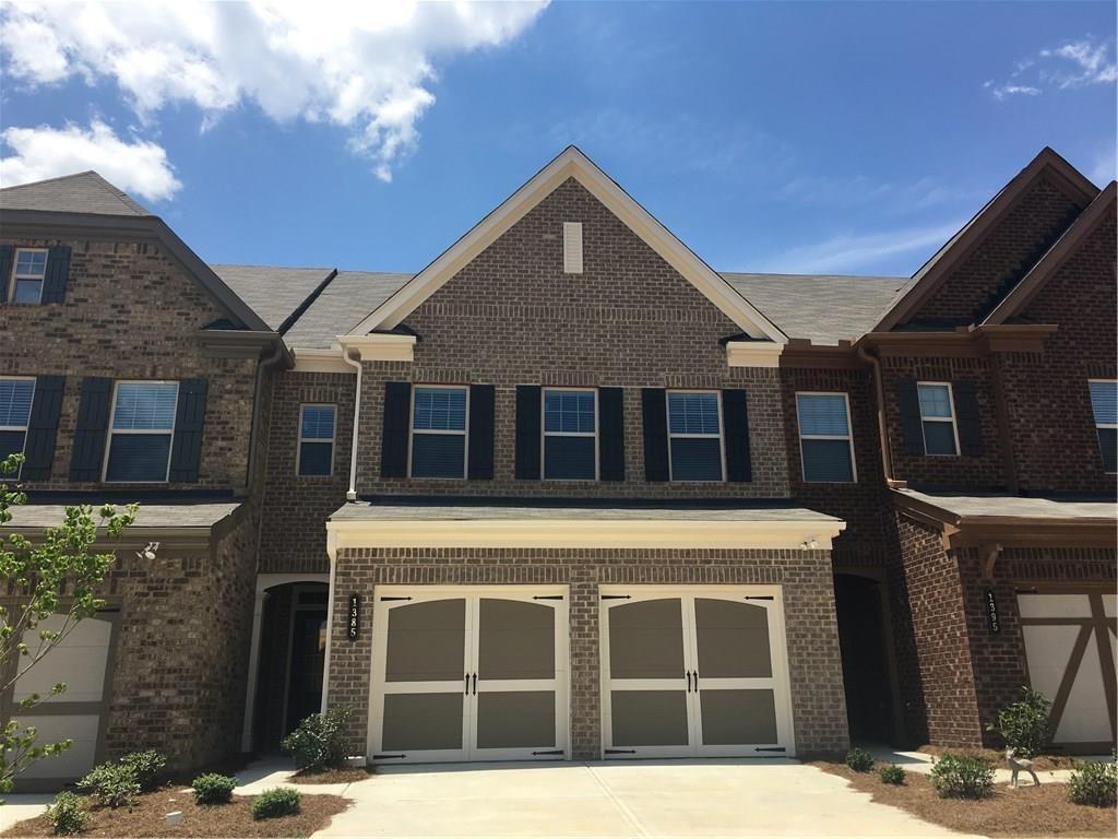 Sought after unit in DENMARK HIGH SCHOOL!! Mins from GA 400 Exit 12, Halcyon. Home has a gorgeous, flat, huge and walk out. Gourmet kitchen open to family room. Hardwoods, stained cabinets, stainless steel appliances. Iron rails and built in cabinets. Pool & tennis in community. 3 bedrooms & 2 baths upstairs. Laundry upstairs.
