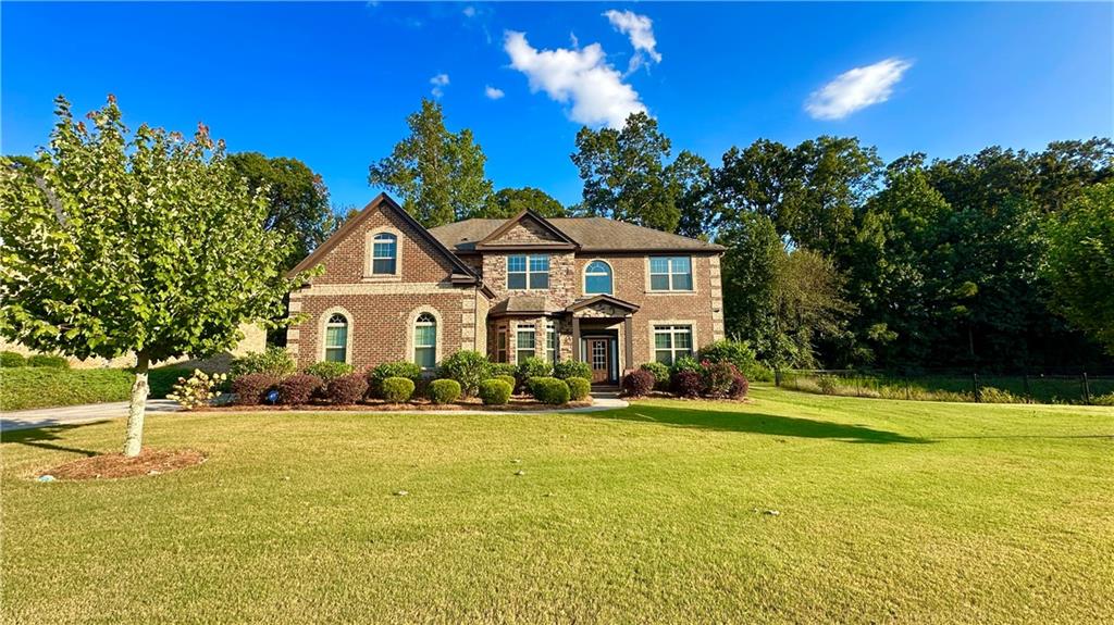 This is the most beautiful, rare to find 4-sided brick house with a large flat professional landscaped corner lot in the sought-after Brookwood School district! Quiet luxury neighborhood, yet easy access to the main road. Two-story entrance with a tray ceiling. Formal living room. Formal dining room with coffered ceiling. Family room with fireplace and ceiling fan. The huge kitchen with 3 stone islands and pendant lights, Lots of cabinet spaces. Breakfast room with a bay window. Guest bedroom on the main floor with a full bath. Harwood floor on the entire main level and NEW carpet upstairs. A ensuite on the upstairs level. The additional 2 bedrooms share a full bathroom. The master bedroom with a huge bonus room that can be used as a nursery, office, or game room. The master bathroom has a separate shower and tub. All bedrooms with high ceilings. A total of 5 bedrooms and 4 bathrooms with over 3800 sq ft provide space, comfort, and privacy. Enjoy morning coffee or afternoon tea on the covered patio overlooking the wooded backyard. NEW paint on the entire interior and front and back doors. Photos tell all, but come to believe it. Price is right to sell!