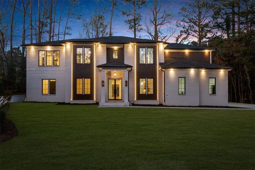 Welcome to 942 Fairfield Drive in the prestigious Indian Hills community of East Cobb! This stunning new construction home boasts four sides of brick, complemented by elegant gas lights and a modern porch with epoxy flooring. Enjoy an expansive 3-car garage with a 220V electric outlet for EV charging, plus a tankless water heater for ultimate efficiency. Inside, the home is equipped with recessed lighting, wired for surround sound speakers throughout, and beautiful wooden and tile flooring. The chef’s kitchen features a custom island with pendant lights, quartz countertops, a Forno 60-inch refrigerator, dual gas/electric stove with 8 burners, smart microwave, and a convenient pot filler. For added convenience, the kitchen island also includes a motorized pop-up outlet with a built-in wireless charger, making it easy to power devices without clutter! The adjoining prep kitchen includes a refrigerator, dishwasher, and sink with under-cabinet lighting, while the full bar offers an ice maker, wine cooler, and wooden countertops. The home’s elegant design extends to the dining and breakfast areas, with LED lighting and rope light crown molding. The foyer greets you with a floating custom lighted box and a striking pendant chandelier, complemented by glass railings and accent wall. The family room features a cozy fireplace, plenty of natural light, more rope lighting, and custom built-ins. The luxurious Primary Suite on the main level includes a custom accent wall, a fireplace, rope lights, and exquisite paneling. Included in the Primary Bath are LED mirrors, a free-standing tub, heated floors, and a smart heated toilet for ultimate relaxation! With exceptional details and high-end finishes throughout, 942 Fairfield Drive is a true masterpiece designed for modern living!