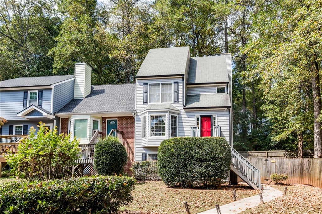 Charming and full of character, this 3-bedroom, 3.5-bath end-unit townhome offers a spacious floor plan plus a highly sought-after basement with a versatile bonus room—perfect as a home office, gym, or easily converted into a 4th bedroom. The oversized primary suite showcases a striking wood beam, soaring ceiling, and private bath, along with access to an upstairs loft-style bedroom. Step outside to enjoy the largest lot in the neighborhood, featuring a HUGE deck and fully fenced yard—ideal for entertaining or relaxing in privacy. All of this in a prime location just 2 miles from Marietta Square, and moments from Kennesaw Mountain, parks, trails, and great dining. Best of all—NO HOA fees!