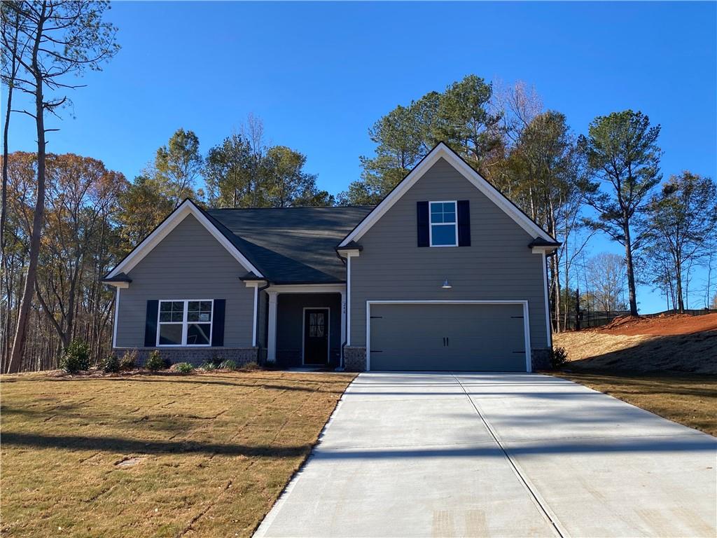 The Charlotte Plan is an open concept plan that features a kitchen island that opens into the family room. Kitchen has granite countertops and white cabinets with Stainless steel microwave, dishwasher, and range. The family has a cozy fireplace. Vinyl floors in the foyer, hall, family, kitchen, laundry and baths. Carpet in the bedrooms. Home has three bedrooms and 2 baths downstairs and has a bedroom and bath upstairs. Large laundry room.