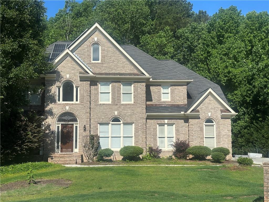 HONEY STOP THE CAR!!!...Tucked away at the end of a peaceful cul-de-sac in the highly desirable Lionshead community, this stately four-sided brick estate offers over 6,000 square feet of refined living space on more than 3 private acres—just minutes from Stonecrest Mall. On one of the larger lots in the neighborhood, totaling five spacious bedrooms and five bathrooms, including a well-designed Jack and Jill bath, this home is perfectly suited for both everyday living and elevated entertaining. The heart of the home features a beautifully updated kitchen with upgraded granite countertops, rich 42-inch cabinetry, and real hardwood floors that flow throughout the main and upper levels. The fully finished basement expands the living area even further, complete with a large living room, a full bedroom and bathroom, and a built-in surround sound speaker system that’s perfect for movie/game nights or hosting guests. Comfort and efficiency are woven into every detail. The property is equipped with solar panels that significantly reduce energy costs and includes three HVAC units—one for each level—with all the systems being replaced within the last four years. The spacious three-car garage includes electric vehicle charging stations, blending classic design with modern convenience. Upstairs, the owner’s suite is a true retreat, offering a cozy fireplace, a sitting area, and a luxurious master bathroom with a jacuzzi tub. Lionshead is a swim and tennis community with a very reasonable HOA, known for its sense of stability—residents who move in rarely ever leave. If you're searching for a home that offers space, privacy, and timeless elegance in a truly welcoming neighborhood, this gem is the one.