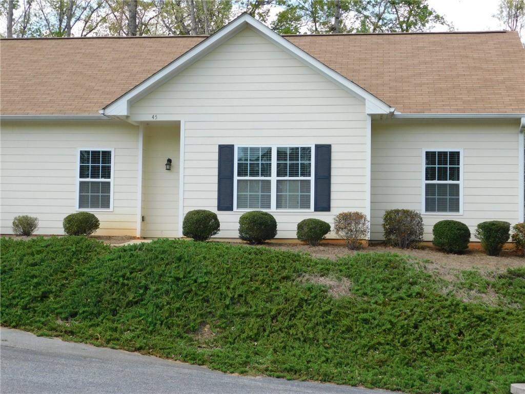 Welcome to this spacious 2-bedroom, 2-bathroom duplex, perfectly situated just off GA 400, offering easy access to Dahlonega, Dawsonville, and the University of North Georgia. This well-designed duplex boasts an open-concept layout, featuring a fully equipped kitchen and a dining area that seamlessly flows into the large living room, creating an inviting space for both relaxation and entertaining. The split bedroom plan provides added privacy, making it ideal for roommates or families. The laundry area is conveniently located within the unit, offering ease and efficiency. Step outside to enjoy your own patio at the rear of the home, perfect for outdoor dining or simply unwinding after a long day. The property also includes level parking and easy access, enhancing your living experience. A monthly fee of $65 covers essential services such as water, garbage, and grounds maintenance, ensuring a hassle-free lifestyle. No pets. **Please note that pictures are not of actual unit but are an accurate representation.