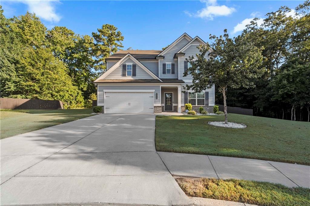 This is a stunning 4 bed 2and a half bath home in Loganville, Georgia offering a perfect blend of modern style and comfortable living. You'll step inside and find hardwood floors throughout, adding warmth and elegance to every room. The kitchen is a chefs dream with granite countertops, stainless steel appliances, and ample cabinet space making it the true heart of the home. Enjoy gatherings in the spacious living areas or retreat to the beautiful screened in deck featuring a cozy fireplace. This home perfectly combines style, function, and location. Don't miss your chance to make it yours!