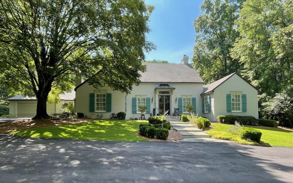 Extremely rare opportunity to live in this exquisite neighborhood on three beautiful private acres. The expansive main level is perfect for indoor and outdoor entertaining, with spacious rooms extending nearly the width of the house, looking out to layers of beauty starting with the mature garden, the pool, and then the mountain. The backyard playground is resplendent with a saline pool, a pool house with fully equipped outdoor kitchen, a full bathroom and a separate changing room. The tennis court was recently resurfaced and pickleball lines were added. Additional features include a vegetable/cutting garden, a new tool house, a dog run and golf cart trails. Interior features boast a carved wood double front door sourced from Europe that opens into a foyer with an arched wood architrave and tile flooring, also from Europe. A Generac generator ensures the house maintains power in severe weather conditions. Hike the mountain directly from your backyard then return and cool off in your pool. The entertaining opportunities both inside and outside are endless. Situated about 400 feet from the base of Kennesaw Mountain, this private oasis is waiting for your enjoyment.