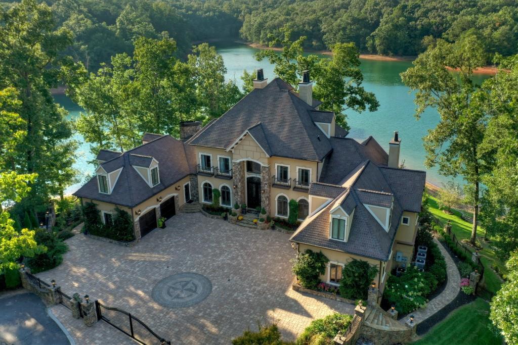 ONE OF THE MOST STUNNING HOMES ON LAKE BLUE RIDGE located within minutes to downtown Blue Ridge! This masterpiece offers elegant, refined & unmatched lake style living with 5BR/4FB/3HB built for entertaining. Main floor features formal living room, formal dining room, office, Gourmet kitchen w/breakfast area & keeping room, master bedroom w/fireplace & spa-like bath, custom tiled flooring & large walk-in closet. 2nd level offers 4 guest bedrooms w/3 private baths & private office/library. 3rd level offers a custom bar, lounge & cozy fireplace. Terrace level offers billiard room, wine cellar, theatre room & exercise room. Outdoor fireplace w/kitchen on main floor, outdoor fireplace on terrace level with pool & hottub. Custom boathouse, 4 car garage w/car lift