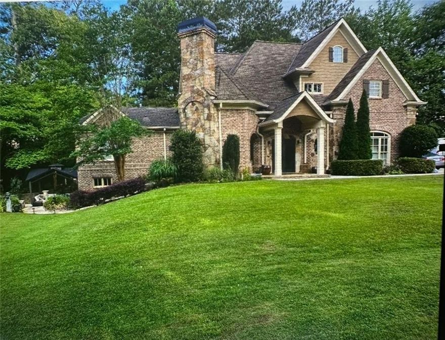 European Old World charm with modern updates in the heart of sought after East Cobb Walton High School location! This unique & versatile property can be enjoyed as a 3 bedroom, 2.5 bath single family residence with roommate/in law suite OR since there are separate entrances as a duplex/investment Airbnb income producing property. If you are looking for multigenerational living or you want to host a short term rental while maintaining your own space, the possibilities are endless! The thoughtful design features a main level with 3" thick field stone, exposed brick walls, and real hardwood floors throughout, an open concept family room and gourmet kitchen with quartz countertops, huge breakfast bar, walk-in pantry, high-end stainless steel appliances (36" Thermador gas stove), and upscale Wellborn kitchen cabinetry. Main level also offers a half bath off of kitchen and access to the attached 3 car garage with large storage room. Back inside, main level offers a luxurious primary suite with en-suite bathroom including double marble vanities, separate dressing vanity, large walk-in shower, walk-in closet, and laundry room. The upper level offers option for a 2nd separate residence with 2 more bedrooms, full bath, 2nd full kitchen, large walk-in pantry, second laundry room, and family room…OR…Design allows for quick conversion of 2nd kitchen to 4th bedroom. The lower/terrace level boasts a large 3rd living room/media room/bedroom with built-in office nook, storage space & safe room that leads outside to a covered lanai overlooking the meticulously maintained .9 acre, lush & level lot. The rest of the outdoor experience is complete with a brick and stone turret lanai with built-in fireplace for year round enjoyment & entertaining. Located close to the areas most highly rated schools, shopping, dining and entertainment, this unique property will not last…Call to schedule your tour today!!