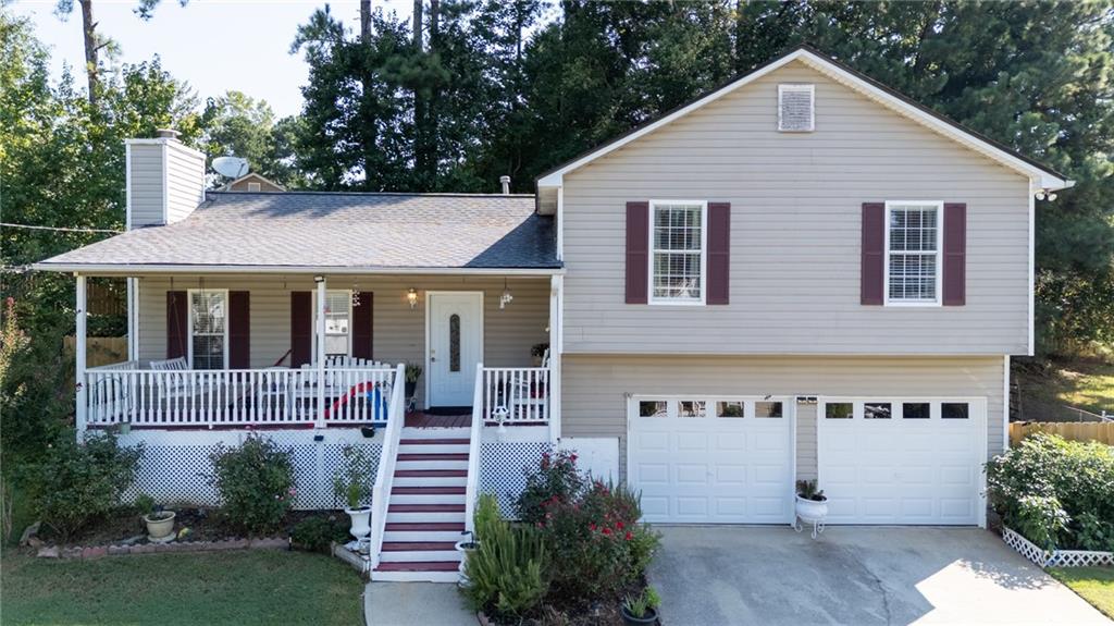 Step into this well-maintained 3-bedroom, 2-bath home where comfort meets convenience. The family room, anchored by a charming fireplace, offers a warm retreat, while the covered rear porch extends your living space outdoors—perfect for morning coffee or evening gatherings. The charming interior offers durable tile and luxury plank flooring throughout. Practical updates bring peace of mind, with a roof just 2 years old, HVAC system approximately 5-6 years old and new insulated garage doors. Tucked in a desirable location, this home is only minutes from conveniences and downtown. A move-in ready gem!