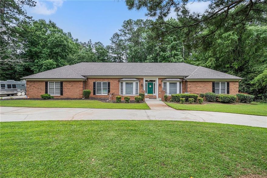 Discover this beautifully updated 4-bedroom, 4-bathroom ranch-style home located at 3003 Hanover Ln SE in Conyers, Georgia. Situated on a spacious 1.15-acre lot in the established Hanover Square neighborhood, this all-brick residence offers both elegance and functionality.

Property Highlights
Size & Layout: Spanning an ample area, this single-story home features a split bedroom plan with two master suites, each equipped with walk-in showers and luxurious bath amenities.

Living Spaces: Enter through a grand foyer adorned with marble floors. The expansive family room boasts a brick fireplace and a wet bar, perfect for entertaining. Adjacent is a serene sunroom overlooking the wooded backyard.

Kitchen: The updated kitchen is a chef's dream, featuring stainless steel appliances, granite countertops, a custom backsplash, and a breakfast bar

Recent Renovations: Enjoy peace of mind with a new roof, gutters, HVAC system, plumbing, lighting fixtures, and luxury vinyl plank flooring throughout.

Outdoor Amenities: The property includes a U-shaped circular driveway, a fenced backyard with fruit trees, an 8-person hot tub, and a 50-amp RV connection. Two street lights enhance the ambiance of the backyard.

Parking: An oversized garage with a storage room provides ample space for vehicles and belongings.