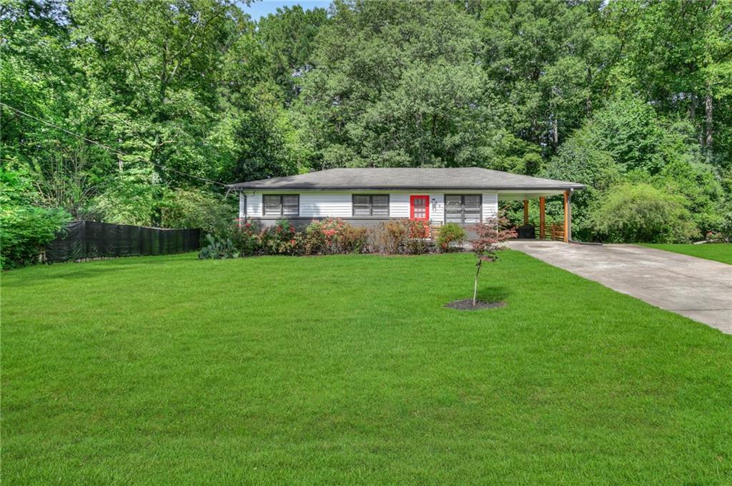 Remodeled Ranch Near Marietta Square!
This stylishly updated 3 bed / 1 bath home is move-in ready and ideally located close to Marietta Square, KSU, Smyrna Village, and I-75. A charming front yard with blooming roses and great curb appeal welcomes you to a recently painted exterior, updated front door, and carport with new wood columns and railings. Step inside to original hardwood floors, new modern light fixtures, and an open floor plan. The renovated kitchen features stainless steel appliances, smart faucet, fresh butcher block countertops, accent tile, and a peninsula perfect for entertaining. The hallway leads to three bedrooms, including a spacious primary with a walk-in closet and ceiling fan. A sliding barn door opens to the newly-updated bathroom with floating double vanity, smart faucets, new tile, lighting, and accessories. Bonus: washer/dryer included! Upgrades include a 2+ year old HVAC system, updated electrical, and a newer water heater. Enjoy a large, flat backyard with a new fire pit, plus plenty of parking with an oversized double driveway and covered carport. No HOA! Just minutes from shops, restaurants, and more.