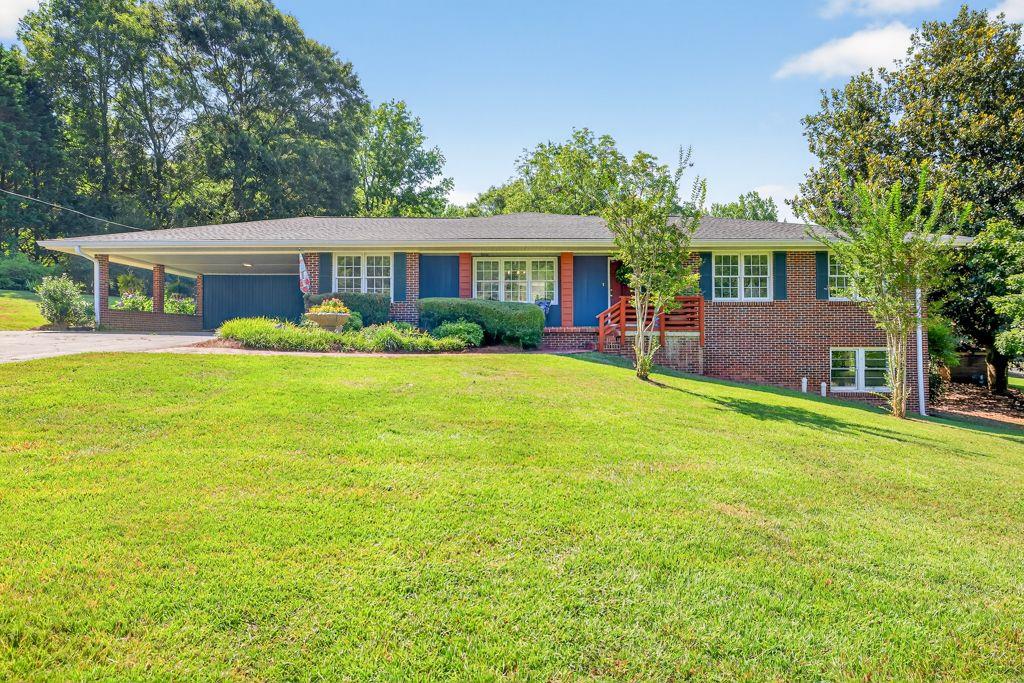 Your Dream Home Awaits – Almost 6 Acres in the Heart of Commerce!
Welcome to your private retreat nestled just one mile from Commerce city schools—where modern luxury meets country charm on nearly 6 acres inside city limits! This beautifully renovated all-brick 4 bed, 2 bath ranch offers the perfect blend of comfort, space, and style. Step inside and fall in love with the custom finishes—batten board accent walls, a handcrafted living room entertainment center, and solid surface flooring throughout. The expansive stone fireplace with a brand-new insert anchors the oversized living room, while the sun-filled kitchen features abundant space, a large walk-in pantry, and a cozy breakfast nook. Hosting is a breeze with a dining room that seats 12+.The primary suite is your personal sanctuary, boasting an oversized closet and a luxurious super shower in the spa-inspired bath. Need flexibility? The 4th bedroom doubles as the perfect office or guest space. The daylight finished basement including finished full bath with an exterior door and separate drive offers multiple options to serve as a secondary master suite, 5th bedroom, private office, gym, or game room. Enjoy Georgia evenings by the outdoor wood-burning fireplace in your entertainer’s backyard. The rocking chair front porch offers a peaceful welcome, while the stocked fishing pond, mature fruit trees, blooming hydrangeas, and magnolia trees make every inch of this property feel like a personal paradise. With multiple storage buildings, 2-car carport + extra parking, new HVAC, and new lighting & plumbing fixtures, this low-maintenance gem checks every box. Don’t miss your rare chance to own this kind of acreage in the city of Commerce—schedule your private showing today and let your dream lifestyle begin! Need money toward closing? Use preferred lender and receive $2500 toward closing.