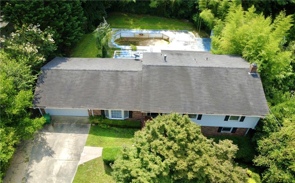 "Renovator's delight" split-level in prime Flair Forest location: two minutes to I-85 and just a couple more to 285/Spaghetti Junction! While this home provides a superb opportunity for the savvy investor, it is also a "move-in-ready," freshly painted home with complete working kitchen including stainless steel gas range, dishwasher, microwave, refrigerator, plus new recessed lighting and ceiling fan! With fully-functional central heating and air, this home is a perfect candidate for buyers who enjoy the challenge of living in their home while renovating at their own pace. (Ask agent how this could potentially create an excellent 1031 Exchange opportunity down the road - with no capital gains upon selling!) The home has hardwood flooring throughout the main and upper levels, and the listed square footage includes a lower-level Sun Room ("Florida Room"), which is also heated and cooled. The level, fenced backyard includes a non-functioning in-ground pool, which could either be re-lined and rehabbed to its former glory or filled in and sodded to create a private backyard oasis. The expansive bi-level deck is also in need of painting and repair, but with potential to be dazzling once restored! The home is also located just minutes from the Shallowford Publix shopping center, which includes dining/take-out options and a cozy neighborhood coffee shop! Also conveniently located to the new Arthur M. Blank Hospital/CHOA complex off of North Druid Hills Rd, and is just a few minutes more to Buckhead and Midtown Atlanta. NOTE: No HOA, No rental restrictions!