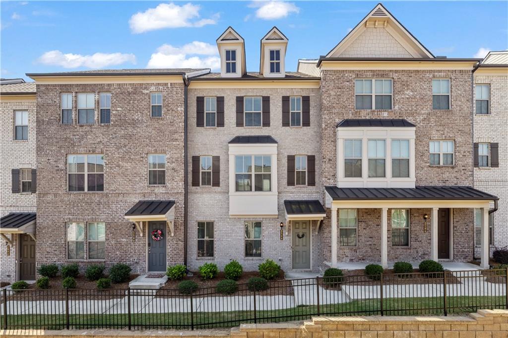 Welcome to this modern 3-level townhome in a luxury gated community within the sought-after Dunwoody School District. Featuring 4 bedrooms, 3.5 bathrooms, and 9’ ceilings, this home is designed for both style and comfort. Highlights include hardwood flooring on the foyer and main level, quartz countertops, stainless steel appliances, a double oven, and a rear-entry 2-car garage. The open concept main level boasts a spacious living area, half bath, and a walkout deck perfect for relaxing or entertaining. Upstairs, you’ll find the oversized primary suite with a spa like bathroom, plus two additional bedrooms, the laundry room, and another full bath. The finished lower level offers a private bedroom with a full bathroom and easy garage access. This community offers resort style amenities: a sparkling pool with private cabanas, bocce court, event lawn, clubhouse, dog park, playground, walking trails, fire pits, and ample guest parking. Ideally situated near I-285 and Peachtree Industrial Boulevard, you’re just minutes from Buckhead, Perimeter, downtown Atlanta, the airport, and the culinary hotspot Buford Highway. With newer construction, you’ll enjoy peace of mind knowing all major systems are up to date, while the oversized primary suite and thoughtful layout create the ultimate in luxury living.