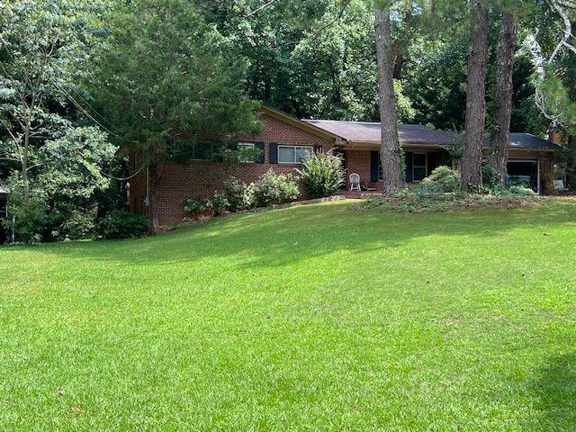 This split level (Ranch Style ) 4 bedroom has a huge kitchen with plenty of cabinets, island, located directly in view of the family room. The brick fireplace would ideal as a central gathering place after a family meal. The home boasts a formal dining room, living room, a converted ensuite bedroom of the back elevated deck. The lower living room has been converted into a two bedroom living space ideal for a short-term rental area. Please note the oversized lot with room to develop, or expand. With minor repairs, and alterations this home could be a showplace.