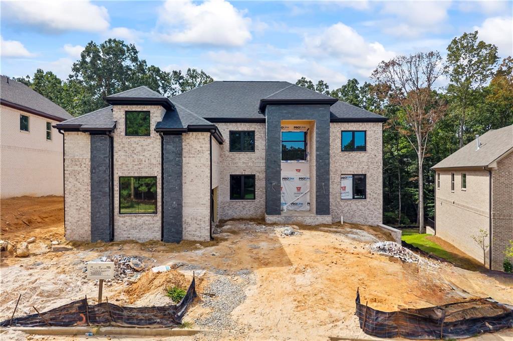 Welcome to a Modern Transitional residence on a full basement nestled in the prestigious community of Le Jardin. Thoughtfully designed and impeccably crafted, this home is scheduled for completion in late September 2025. From the moment you enter the grand two-story foyer, you're greeted by a catwalk view that overlooks both the entry and the soaring 2-story great room, setting the tone for the home's elevated, open-concept design. To the right, a formal dining room awaits and to the left, a dedicated home office. Curated designer lighting throughout the home accentuates each space with luxury and warmth. The two-story great room is flooded with natural light from a wall of windows and seamlessly flows into the chef's kitchen-a true showpiece featuring quartz countertops, a dramatic waterfall island, and an expansive walk-in pantry and a gas cooktop. A spacious guest suite on the main level with ample closet space and a thoughtfully designed mudroom off the two-car garage add both convenience and style. Upstairs, the luxurious Owner's Suite is a true retreat, featuring a fireside sitting area, spa-inspired bath with a soaking tub flanked by dual quartz vanities, an oversized glass shower, custom his-and-hers closets, and a private study or flex room just beyond the closets. Three generously sized secondary bedrooms each offer en-suite baths with frameless glass showers and sleek fixture. Located minutes from Camp Creek Marketplace, Hartsfield-Jackson Airport, golf courses, downtown Atlanta, and less than 30 minutes from Woodward Academy, this location combines luxury and accessibility. Incentives: Use preferred partners Toshia Parrish with Assertive Mortgage and The Hawes Law Firm to receive up to $5,000 in builder concessions. Early contracting allows for select design customizations. Don't miss your chance to own this one-of-a-kind home in one of South Fulton's most exclusive communities.