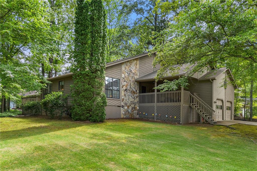 Tucked away perfectly with no-thru traffic and surrounded by old-growth trees, this inviting 3-bedroom, 2-bath home offers a sense of space, privacy, and timeless charm—just minutes from the heart of Downtown Woodstock.
From the moment you arrive, the oversized front porch welcomes you in, offering the perfect spot to sip sweet tea and watch the seasons change. Out back, a generously sized deck stretches across the home, made for summer cookouts, fall evenings by string lights, and gatherings with family and friends. Whether you dream of garden beds, or a play space, this yard delivers the room to make it all happen.
Inside, high ceilings and a cozy gas fireplace anchor the living space, with views of the surrounding trees from the windows. The layout is practical, with just enough charm to feel warm and lived-in, while offering a solid canvas for your personal touches and modern updates.
Additional perks include a detached storage shed, Leaf Guard gutters with a No-Clog warranty, and plenty of overhead storage in the oversized garage. Major systems are in great shape—with a transferable 25-year roof warranty, long-standing termite bond, and HVAC and water heater warranties for peace of mind.
And perhaps best of all? No HOA restrictions, and just across the street is protected Corps of Engineers land, ensuring a natural view that stays untouched.
This is the kind of home where memories are made—where hospitality is easy, and the setting invites you to slow down and stay awhile. All just 2.5 miles from the shops, restaurants, and energy of Downtown Woodstock.