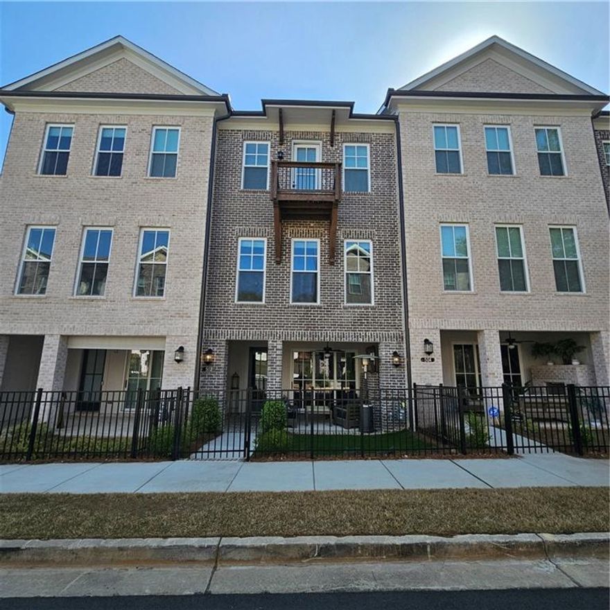 Just WOW!!! Gorgeous Practically BRAND NEW townhouse!! Hardwoods throughout. Main level completely open floorplan with huge open kitchen with quartz counter tops, stainless appliances, awesome refrigerator, 5 burner cooktop, tiled backsplash and walk in pantry. Open family room with gas fireplace. Main level flex room with exterior door out to rear deck and half bathroom. Main level laundry room with cabinetry. Tankless water heater. Upstairs with nicely sized owners suite with custom accent wall and exterior door out to deck. Owners suite bathroom is gorgeous as well with free standing soaking tub, huge double headed shower, double vanities and HUGE walk in closet. 2 additional bedrooms upstairs each with an exterior door out to a deck. Full hallway bathroom upstairs as well. Lower level with den/rec room/office with a wall of doors that completely open up to an outside entertaining area that is fenced and has a gorgeous brick fireplace! 2 car rear facing garage wtih EV charging station. If you're not familiar with Atley neighborhood its gated, has a community pool and is DIRECTLY on the Alpha Loop which takes you to all the hot spots of Alpharetta. Literally a few minutes walk to DT Alpharetta and Avalon, the perfect location!!