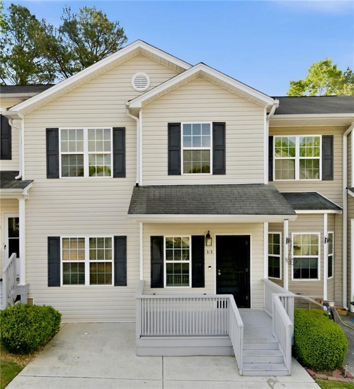 Welcome to 313 Venture Path- Charming townhome with inviting curb appeal and covered front entry