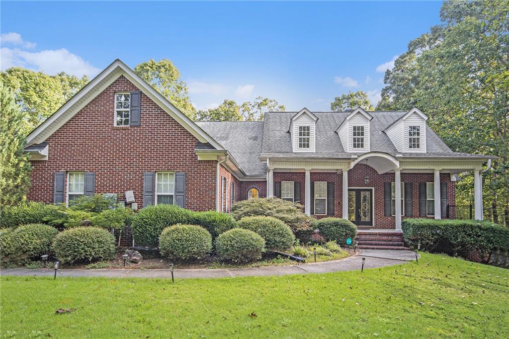 Stunning 4-Sided Brick Home on 4.22 Acres in Danielle Estates
Welcome to this remarkable 4-sided brick home, perfectly situated on 4.22 fully fenced acres in the desirable Danielle Estates subdivision. Tucked away on a private wooded lot, this property offers both comfort and seclusion with a long driveway that wraps to the rear of the home, leading to an attached garage and spacious parking pad. The expansive backyard is perfect for entertaining, complete with a firepit and additional outdoor sitting area.
Step up to the full-length covered front porch and through the double-door entryway, where you are greeted by a soaring vaulted foyer with beamed ceilings and hardwood floors throughout. The formal dining room, with space for up to 12 guests, is accented by wood beams for a warm and elegant touch.
The large living room features built-in shelving and cabinetry framing a stacked stone fireplace, creating the perfect spot for gatherings. The open-concept kitchen offers stained cabinetry, double ovens, an electric cooktop, and a large island. An adjoining breakfast area overlooks an additional den, providing even more living space on the main level.
The private owner’s suite is located on its own wing of the home and boasts cathedral-beamed ceilings with wood accents, a spa-like renovated ensuite with double vanities, tile flooring, a soaking tub, a tiled shower, and a generous walk-in closet. Two additional bedrooms on the main level share a convenient Jack-and-Jill bathroom.
Upstairs, you’ll find a full in-law suite with a private living area, full bedroom and bathroom, walk-in closet, extra coat closet, and attic storage.
The fully finished basement offers limitless possibilities—featuring a large living room, additional bedroom with closet, a gym or theater-ready flex room, dining area, multiple storage rooms, and a full workshop with a boat door.
This one-of-a-kind property combines privacy, space, and functionality in a premier location. Don’t wait—schedule your private tour today and experience all this home has to offer!