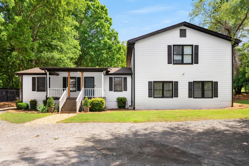 Welcome to your private retreat in the highly sought-after West Forsyth District! This beautifully updated split-level ranch sits on more than an acre of peaceful, usable land tucked away from busy roads for added privacy. With classic farmhouse charm, this home features a welcoming rocking chair front porch and a spacious back deck, perfect for relaxing or entertaining. Walk inside to find a move in ready and fully updated spaced. The main living area boasts a new kitchen with island seating, quartz counters and stainless appliances. Throughout the home,, you'll find updated bathrooms and numerous modern upgrades throughout. The primary suite offers a true retreat - a quite breath-taking sized bedroom, beautiful bathroom and multiple closets with custom closet systems. Enjoy the charm of country living without sacrificing convenience. This property offers room to grow, play, and unwind, all in a location known for top-rated schools, nearby amenities, and a strong sense of community. Don't miss your chance to own this unique and beautifully maintained home in one of Forsyth County's most desirable areas. Reach out to the listing agent, Patrick Casey with any questions and to schedule your showing.