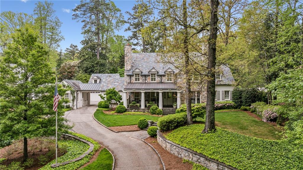 Fabulous Price Adjustment ! Everyone's Favorite. This charming home with a slate roof in the middle of Historic Brookhaven is a true dream with a magazine-worthy yard. You will love the 10' & 12' ceilings and the beautiful heart pine floors, plus 4 wonderful fireplaces. An oversized dining room is ready for entertaining and two wonderful offices are perfect for today's lifestyle. The main level master looking over the lush backyard also opens to one of the 3 covered porches. If you are looking for a walk- out backyard, you have found it, complete with curving stone walls, custom hardscapes, private sitting areas, and a bubbling fountain. The seller has even had pool plans designed if that is your desire. The expansive kitchen with double islands, 3 ovens, 2 dishwashers and more opens to a vaulted ceiling family room looking out over the beautiful yard. Need a wine cellar? We have it along with a game room with a pool table, a terrace-level kitchen/bar, a media room, and the most professional gym you will ever find in a home. The bedrooms are all very spacious each with ensuite baths. A 3 car garage, a gated driveway, and an oversized rocking chair front porch make this the most delightful retreat in Historic Brookhaven.