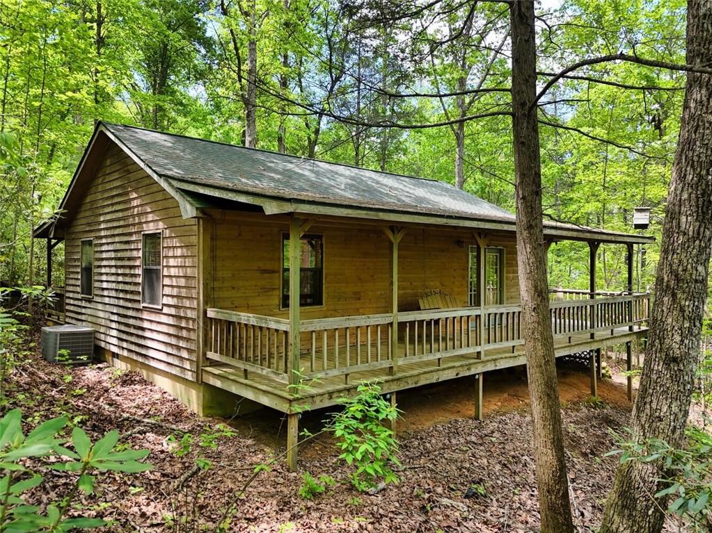 MOTIVATED SELLER! Private 4.75-Acre Mountain Retreat — Endless Potential Awaits. Discover the charm and possibility of this 2-bedroom, 2-bath cabin tucked away in the peaceful Fortenberry Creek subdivision in the sought-after Owl Town area. Set on 4.75 acres—including three additional lots—you’ll enjoy unmatched privacy, room to expand, or the option to build additional homes.
This rustic mountain retreat is a true diamond in the rough, ready for your personal touch. Whether you’re seeking a cozy weekend getaway, full-time residence, or investment opportunity, this fixer-upper offers a rare chance to craft your own mountain escape. The home features a small outdoor building for extra storage, while the surrounding acreage invites dreams of tranquil outdoor living spaces.
Surrounded by serene natural beauty, yet just minutes to Blairsville’s charming shops, dining, hiking trails, and lakes, this property offers the perfect balance of seclusion and convenience. Bring your vision and creativity — this is your opportunity to transform a hidden gem into something truly special!
