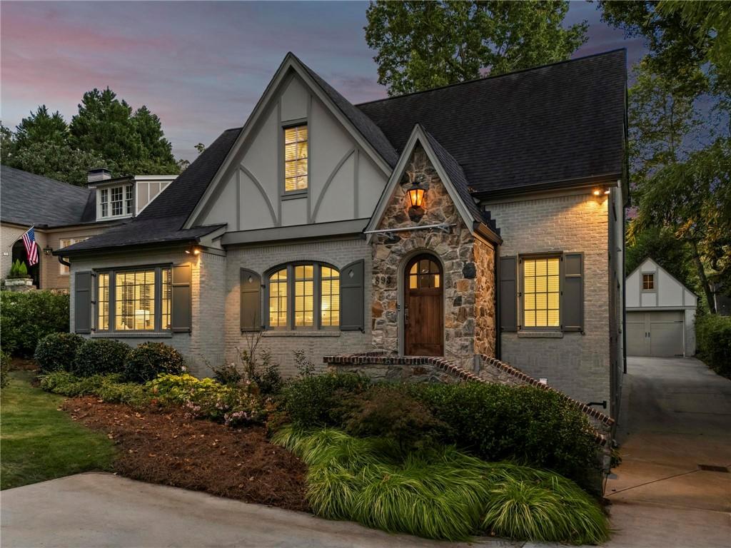 Quintessential Morningside Tudor, expertly renovated and expanded by Horner Homes in 2018, is a dream retreat in an idyllic location. Lush landscaping, generous parking, and a charming front porch make for an easy welcome to greet guests upon arrival. Once inside the arched front door, an open floor plan, high ceilings, extensive trim package and timeless hardwood floors will impress the most discerning eye. The fireside sitting room overlooks the front gardens and opens to the large formal dining space, set beneath a new designer chandelier. Tucked behind a pair of pocket doors, the vaulted office space means serious business. At home chefs will surely delight in this gourmet kitchen boasting a butler’s pantry, custom millwork cabinetry, oversized marble island and commercial grade appliances. The rear half of this main floor is meant for casual entertaining with its sun-drenched breakfast nook, fireside family room (complete with surround sound upgrades and charming French doors), plus a useful mudroom with delightful storage. Rounding out the first level is a cute powder room and an oversized guest suite with generous walk-in closet and private en-suite bathroom. Upstairs you’ll find a massive primary suite complete with a sitting area overlooking the rear courtyard and an in-room wet bar ready for morning coffee. Dripping in marble, the lavish primary bathroom is an expert showcase in timeless design with dual vanities, large shower, soaking tub, and access to the oversized walk-in closet with custom cabinetry. The upstairs laundry room makes the inevitable chore a bit more convenient and manageable. Two additional guest bedrooms, each with private en-suite marble bathrooms, and attic storage complete this upper level. Outside, the stone courtyard exudes old world charm and overlooks the flat, fenced backyard featuring a custom playset and mature trees for ample privacy. Don’t miss the detached one car garage plus more homeowner parking behind the driveway gate. Tree-lined streets with sidewalks, friendly neighbors, pocket parks and top-rated schools define the Morningside neighborhood. Enviable location is moments from Piedmont Park and the Beltline plus local favorite restaurants, boutiques, and coffee shops. You will be hard pressed to find another home in all of intown Atlanta that marries charm and luxury so seamlessly with modern livability. Welcome home to 893 E Rock Springs, where life is good and living is easy.