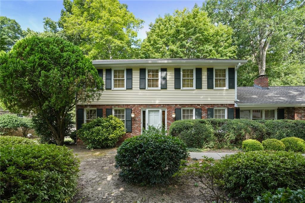 Welcome to this traditional Dunwoody gem nestled in the coveted Windhaven neighborhood! On the main level is a separate living room and a formal dining room, both with hardwood floors. The family room features a brick fireplace flanked by built-ins.
The bright kitchen boasts granite countertops, white cabinetry, stainless steel appliances, and a cheerful breakfast area with views of the backyard. A convenient main-level bedroom offers flexibility for guests or a home office.
You'll find the primary bedroom on the upper level with 2 additional bedrooms. Step outside to a large stone patio that opens to a private, flat backyard, perfect for play, gardening, or pets.
Incredible location! Just minutes from Dunwoody Village, the JCC, Brook Run Park, top-rated schools, local swim/tennis clubs, and easy access to 285/400, this home combines comfort, convenience, and community. No Seller's Property Disclosure.