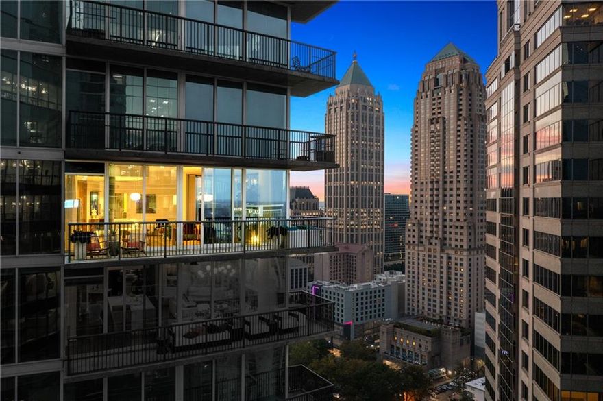 A rare, high-floor “03-stack” at 1010 Midtown—1,505± SF of glass-walled city living above Peachtree. French oak herringbone floors (refinishable twice) lead to a sun-splashed great room wrapped in floor-to-ceiling windows and a deep balcony for golden-hour skyline views. The chef’s kitchen is elevated with Calacatta Macchia Vecchia waterfall-edged marble slab countertops + full-height backsplash (a coveted quarry now closed), upgraded range/microwave/disposal, generous cabinetry, and an easy flow for everyday cooking or entertaining.
The split bedroom plan maximizes privacy. The serene primary suite features a custom California Closets system and a spa-quality bath appointed with natural quartzite counters, upgraded faucets and shower hardware, and a custom-height low-iron glass shower enclosure for crisp clarity. The gracious secondary bedroom is ensuite and enjoys a professionally sound-proofed wall—ideal for rest, work, or media. A chic powder room with pedestal sink serves guests with style. Throughout the residence, details are thoughtfully refined: taller upgraded baseboards, tile flooring in all baths, custom mirrors, and designer lighting that carries through halls and living spaces.
Baths are uniformly upgraded: quartzite countertops in each full bath, new Kohler comfort-height toilets in every bath, refreshed fixtures (faucets, shower, and tub hardware), and custom- height, low-iron glass enclosures that feel bright, open, and premium. These tactile, daily-use
upgrades materially enhance how the home lives. The kitchen’s statement marble—paired with the warmth of herringbone oak—creates a cohesive, design-forward palette that transitions seamlessly into the window-lined living and dining zones. Everyday convenience and thoughtful
finishing touches give the home a polished, editorial feel.
Turnkey systems mean peace of mind: new HVAC (installed March 2025, under warranty) and water heater (installed November 2022). The home’s lighting and electrical are dialed-in for modern living with dimmer and timer switches throughout. Storage is abundant and organized thanks to California Closets in every major closet. The washer + dryer remain with the home for true move-in ease.
Parking and access are best-in-class: two premium assigned spaces on the first resident level (highly desirable for quick in-and-out), electric charging station (no longer available in the community), controlled access, and an efficient elevator stack right to your floor.
Life at 1010 Midtown adds the city’s favorite amenity level—an expansive 8th-floor sky garden with resort-style pool, clubroom, grilling + entertaining terraces, and a well-equipped fitness center—plus 24/7 concierge and professional management. Step out to landmark dining,
cafés, and culture, with Piedmont Park, the BeltLine connectors, Colony Square/Politan Row, and MARTA close at hand.
Residence 2503—the sought-after 2BR/2.5BA “03” plan—pairs fully upgraded, design-driven interiors with the lock-and-leave ease of Midtown’s most iconic address. Turnkey systems, rare marble, refined baths, and premium parking—delivered in one sophisticated, move-in-ready
package.