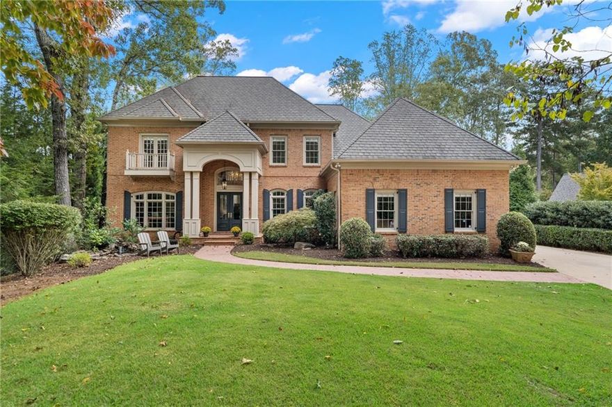 Set within the distinguished gates of Country Club of the South in Johns Creek, this elegant four-sided brick estate home offers the perfect blend of privacy, comfort, and timeless sophistication. Surrounded by mature trees and lush landscaping, the residence sits on an expansive, private wooded lot that captures tranquil golf course views of the men’s 7th tee box and fairway. Designed for easy, refined living, this home provides a serene retreat while remaining just moments from world-class amenities and top-rated schools. A thoughtfully landscaped front yard welcomes you with a peaceful koi pond and gentle water feature, setting the tone for the calm elegance found throughout the property. The backyard is a true sanctuary and is spacious, secluded & beautifully maintained, with plenty of room to accommodate a pool if desired. Outdoor living is a highlight here, featuring a large deck, a newly installed paver patio with an inviting fire pit, and captivating natural surroundings that make entertaining or relaxing feel effortless. Inside, the home’s gracious design emphasizes warmth, functionality, and natural light. Rich hardwood floors span the main level, leading into a bright, open kitchen equipped with a generous island, Thermador five-burner gas cooktop, double ovens, and breakfast area perfect for both casual dining and hosting gatherings. The adjoining keeping room, bathed in sunlight from new windows, invites you to enjoy serene backyard views in comfort. The two-story great room showcases a striking stacked-stone fireplace and new 8’ doors that open to the deck, creating a seamless flow between indoor and outdoor living. The main-level primary suite offers a peaceful escape with ample space and convenient main-floor access for ease of living. A handsome study or music room provides versatility for work or relaxation. Upstairs, three additional bedrooms offer comfortable accommodations—one with an updated ensuite bath and two additional bedrooms with a Jack & Jill updated bath. The terrace level adds even more flexibility, featuring newer luxury plank flooring, a cozy stacked stone fireplace, a stylish bar area, a media room, and an additional ensuite bedroom with a large closet ideal for guests. Offering a rare combination of privacy, elegance, and effortless livability, this residence invites you to enjoy the best of Country Club of the South living where comfort, natural beauty, and community come together in one of Johns Creek’s most desired communities. This is truly a must-see estate property.  This outstanding value won't last long!