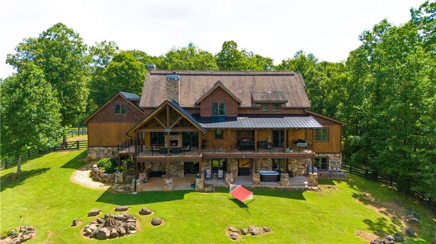Don't miss this incredible opportunity to own the ultimate mountain retreat at 98 S Saddleback Trail, Blue Ridge, GA! This magnificent 6,975 sq. ft. estate boasts 4 king master suites, each with ensuite baths featuring luxurious tile showers, oversized soaking tubs, custom walk-in closets, and serene sitting areas. Plus, a versatile bunk room or playroom adds to the home's charm. Enjoy cozy evenings by one of the three wood-burning fireplaces with gas starters or unwind in the brand-new Dimension One hot tub. The house is equipped with modern conveniences, including a whole-house Generac backup generator, two tankless hot water heaters, and a whole-house water filtration system. High-speed fiber optic internet upgraded to 1000 Mbps ensures you're always connected, with a point-to-point system extending Wi-Fi to the barn and the 1,500 sq. ft. storage building/workshop. The four-level home sits on a sprawling 9.38 acres with two healthy pastures perfect for animals, year-round grass, and cross-fencing. Additional highlights include a two-car garage, gated entry, all-paved roads, and a past successful STR history. The property offers stunning long-range mountain views, hardwood, and tile flooring throughout, and a partially finished 2,790 sq. ft. basement with plumbing, HVAC, and electrical ready for your finishing touches. Embrace the mountain lifestyle with everything you need for comfort, luxury, and outdoor enjoyment!