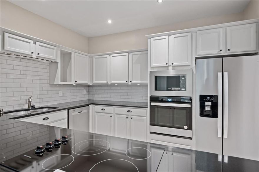 GROUND FLOOR UNIT = No Stairs or Elevator. Private rear covered patio! Kitchen was just updated with Brand New Stainless Steel Appliances, Beautiful New Backsplash, Beautiful Off-white Cabinets, and Granite countertops. Split-bedroom plan would be perfect for roommates. Location Location Location. Very short walk to Ameris Bank Amphitheater. <5 minute Drive to Downtown Alpharetta & North Point Mall. Quick Access to GA400. HVAC & Water Heater were just replaced a few years ago. Washer & Dryer Included with Sale. Up to $10k in Closing Cost Contributions or Buyer upgrades available.