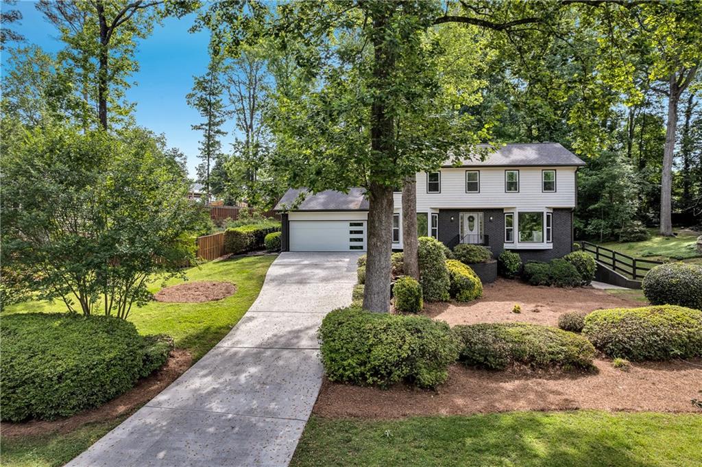 Welcome to this beautifully renovated 4 bed, 3.5 bath home located in the highly sought-after Indian Hills community of Marietta. Situated in the award-winning Wheeler Magnet School district, this home offers modern upgrades, and an unbeatable East Cobb location. Freshly painted inside and out, this home features a brand-NEW roof, NEW windows, NEW garage door, NEW AC compressor, NEW water heater, NEW slow-close cabinetry, NEW light fixtures, and all-NEW flooring throughout. The open-concept main level welcomes you with a dramatic black brick fireplace, custom built-ins, and an enclosed sunroom that fills the home with natural light. The chef’s kitchen is a true highlight, showcasing crisp white cabinets, NEW quartz countertops, a stylish tile backsplash, gold hardware, and a sleek black vent hood over a gas range, perfect for everyday living and entertaining. Upstairs, the spacious owner’s suite offers a spa-like retreat with a double vanity, frameless glass shower, and walk-in closet with a modern barn door. Secondary bedrooms are freshly updated and share a beautifully renovated hall bath.The fully finished basement expands your living space with a full bathroom, wet bar, and a versatile room ideal for a home office, guest suite, or game room. Outside, enjoy a private backyard with a custom gravel patio and fire pit area, ideal for gatherings or quiet evenings. Move-in ready and upgraded, this home offers timeless design, modern comfort, and convenient access to I-75, East Cobb Avenue, and Historic Marietta Square. Don’t miss your chance to make this East Cobb GEM your own!