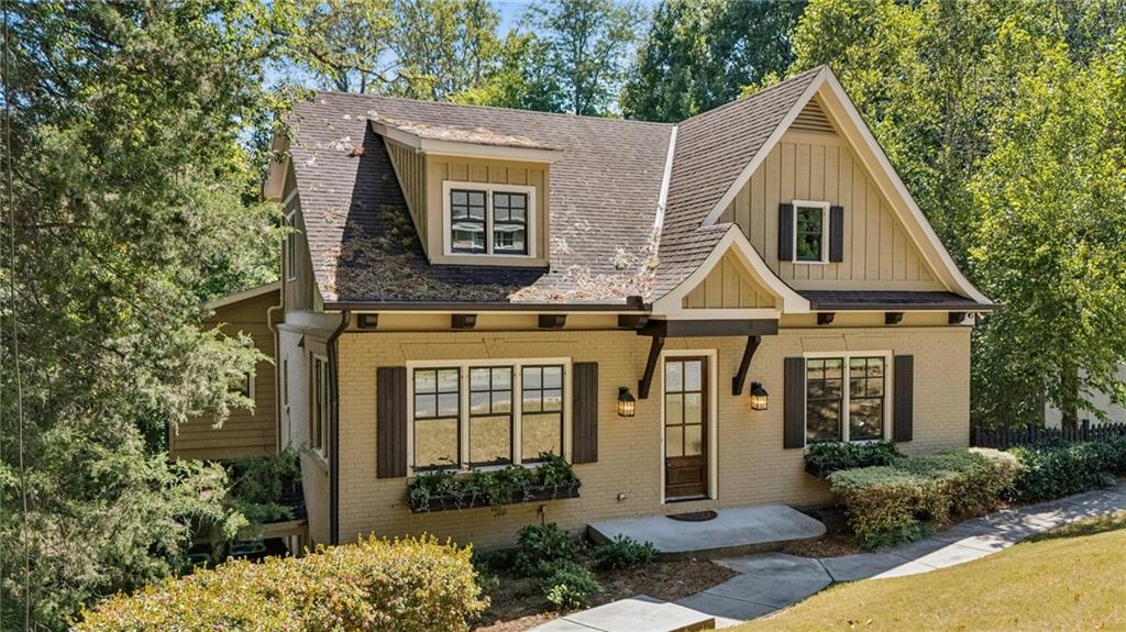 Sophisticated painted brick home in Peachtree Heights East with wood accents and delightful planter boxes filled with color to welcome you home. Front door takes you to the formal but warm dining room with coffered ceiling and easy access through the butler's pantry opening to the kitchen. A timber framed opening accentuates the painted cabinets, granite counter tops, stainless steel appliances, pot filler, and double sinks for ease of use make this a well designed space for any culinary desire. Breakfast nook just waiting for a custom banquette. Vaulted family room with fireplace flanked by floor to ceiling bookshelves. Just off the den is the screened in side porch providing a shady perch that leads to the back deck. Conveniently located primary bedroom off the main level with primary bath in neutral tones. The 2nd story features two large bedrooms with built ins, new hardwoods, and en-suite baths. Unfinished storage areas offer opportunity for easy expansion. Laundry room is on the 2nd level. Open staircase towards the front of the home leads to finished basement with tiled floor, bar stool island, mini kitchen opportunity perfect for hosting sporting events. Lower level has the 4th bedroom, dedicated office, mudroom, plus full bath and half bath. 2 car drive under garage with freshly sealed floors. Plenty of driveway space for turn around, additional parking, basket ball goal, etc. Lovely level yard is beautifully maintained. 8 minute walk to the Duck Pond, .7 mile to AIS, 10 minutes to the best shopping Buckhead has to offer.