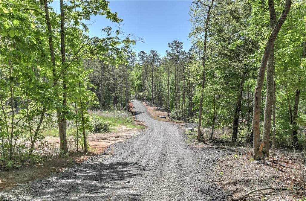 Discover your own private retreat with this stunning 5-acre parcel of gently rolling land, perfectly nestled in nature’s embrace. Whether you’re looking to build a slab or basement-style home, this property offers multiple ideal building sites with beautiful topography and serene surroundings.
Located away from the hustle and bustle, this peaceful escape provides the privacy and quiet you crave—yet it’s just minutes from modern conveniences. Enjoy quick access to shopping, golf courses, Reinhardt University, and the newly built Cherokee High School.
This is your opportunity to build your dream home in a location that offers the perfect balance of seclusion and convenience. Bring your builder, your vision, and make it yours today! Please do not go on the property without an appointment and a licensed real estate agent.