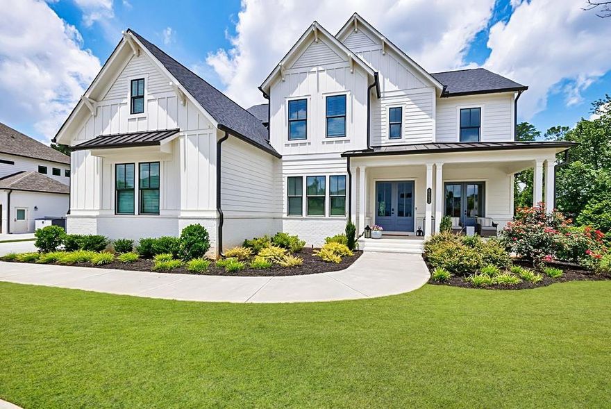 This stunning custom-built residence features the largest floor plan you will find in the prestigious gated community Tanglewood Enclave. From the moment you step onto the front porch, you will notice the custom laid herringbone brick details and Double French doors. Once inside, you'll be captivated by the designer finishes that adorn every corner of this exceptional residence. This kitchen is a dream with a farmhouse sink, oversized island, stacked cabinetry to the ceiling with Glass fronts, large drawers and upgraded appliances make this truly a dream area to cook and entertain. The 48” Monogram built-in Stainless Steel Refrigerator, 48” Monogram Gas Apron front cooktop with griddle, double ovens, microwave drawer and pot filler will make cooking your new favorite hobby.  Off the Great Room, the triple slider opens to the covered deck with retractable screens to keep it more temperature controlled and more open when desired. Upstairs you will find the owner's suite is a true sanctuary, complete with a luxurious bathroom featuring a freestanding tub and an oversized shower with two entrances, multiple shower heads, benches and niches, offering a spa-like experience. The custom owner’s closet is perfectly designed to meet your every need with built-in cabinets, drawers, lights and mirrors. Each secondary bedroom has an ensuite full bath with a walk-in closet. As you walk down to the open finished basement, you will find that it offers additional living space, perfect for entertaining or creating a private retreat that you have been looking for. The attention to detail is evident in the trim work that enhances the elegance of each room. The large basement bar will be the new center of entertainment with a large island, sink, two undercounter refrigerators, shelves, Glass custom cabinetry, quartz countertops and more.  This home was custom designed so there is nothing like it! Schedule your private tour today!