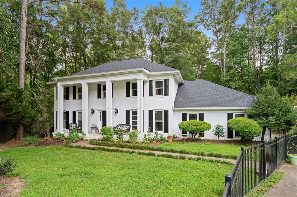 Set on a full acre in one of the area’s best school districts, this home offers the perfect balance of privacy, space, and convenience. Nestled on a quiet street, it’s surrounded by mature trees and thoughtful landscaping that frame both the front and fenced backyard, giving you plenty of room to relax or entertain. It feels like a retreat while keeping you just minutes from restaurants, shopping, and the city. Inside, the kitchen with custom cherry cabinets and stainless appliances opens into a light-filled family room with a cozy fireplace—an easy spot for everyone to gather. A flexible bonus room connects off the main living area, while the wood-paneled office makes working from home feel classic and comfortable. Guests will love the main-level bedroom and full bath. Upstairs, the spacious primary suite includes a walk-in closet and updated bathroom, paired with three more bedrooms and another renovated bath. Downstairs, the unfinished basement provides over 2,200 square feet to create whatever you need next—home gym, rec space, theater, or storage. With a water filtration system, brand new roof, plus newer windows, gutters, HVAC, and attic insulation all just a few years old, this is a move-in ready home that blends timeless style with everyday comfort, offering room to grow and a location that makes life easy.