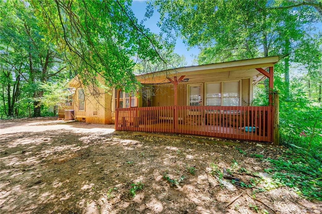 Solid Opportunity on Over 3 Private Acres! This 3-bedroom, 2-bath ranch offers strong bones, recent major upgrades, and endless potential. Featuring a newer roof, HVAC, and well, the home is ready for your finishing touches. Inside, you'll find a spacious floor plan with vaulted ceilings, a dramatic floor-to-ceiling stone fireplace, and a split-bedroom layout perfect for privacy. Whether you're looking for a great flip, a rental, or your next primary residence, this property fits the bill.