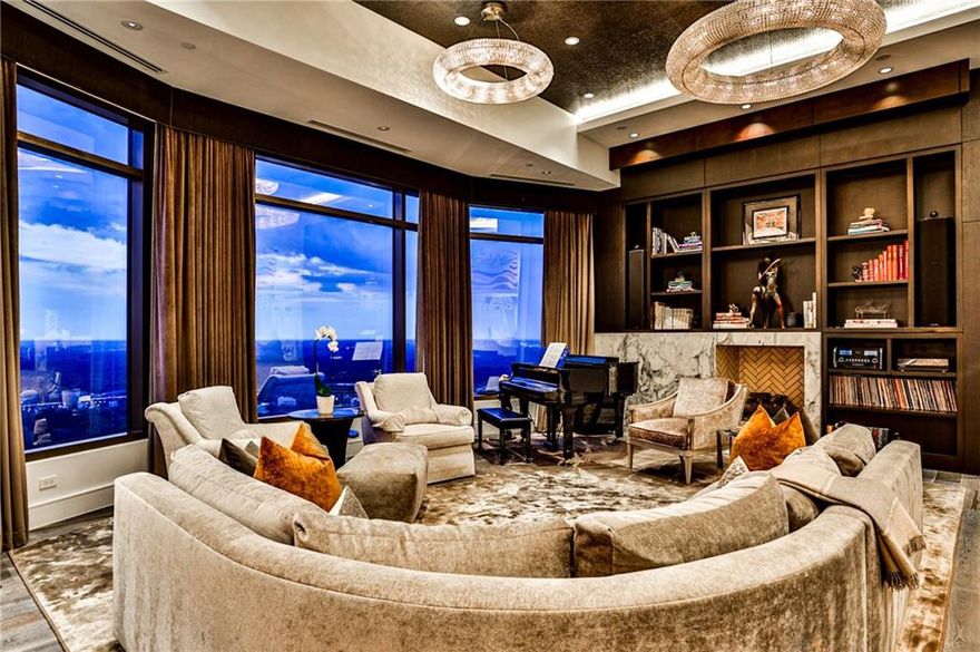 Experience the pinnacle of luxury in this full-floor Waldorf Astoria Penthouse, custom-designed by Jim Weinberg. This exclusive Buckhead residence, completed in 2019, offers unparalleled 360° city views through oversized picture windows. A private elevator opens to a grand foyer and a magnificent great room. The gourmet kitchen is a chef's dream with Quartzite countertops, Sub-Zero and Wolf appliances, and four wine coolers. This smart home features three fireplaces, motorized shades, and two private balconies. Residents enjoy world-class amenities, including a state-of-the-art fitness center, 24-hour concierge, and four valet parking spots. The lavish primary suite boasts a sitting area, fireplace, custom closets, a spa-like bath, and a private balcony. This is a true sanctuary for those seeking an extraordinary living experience.