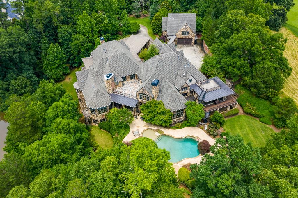 An unequivocally magnificent property, this grand custom estate offers an incomparable lifestyle of luxury and privacy situated on 2.82+/- acres overlooking the 18th hole of the prestigious TPC Championship Course at Sugarloaf Country Club. Eye-catching attention to detail blends refined elegance with an inviting warmth throughout the home highlighted by the use of finely crafted woodwork, rustic stone accents, designer lighting and intricate moldings. An abundance of natural light creates an inviting main level anchored by the smartly configured kitchen featuring two massive islands, premium appliances, a large walk-in pantry, custom cabinetry, and an open layout flowing into the light-filled family room and breakfast area. The spectacular daylight terrace level offers every amenity expected in a home of this caliber including a state-of-the art theatre, billiard room, bar, workout room and large flex area. Outdoor living takes priority with multiple entertaining areas, a heated Pebble Tec pool and lake access. Additional enviable features include all en-suite bedrooms, separate apartment upstairs in main house, a well-appointed guest house, oversized six-car garage and Creston whole-house entertainment system.