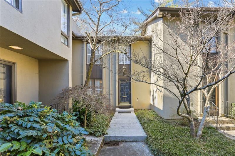 Incredible opportunity in The Ivy's in the heart of North Buckhead! This home is located in an ideal quiet location in the neighborhood and backs up to common area greenspace. Features include hardwood floors, built in bookshelves, fireplace, tons of storage space, and an open floorplan practical for everyday living and entertaining. This home offers two bedrooms, two full bathrooms, a powder room, flexible terrace level space for media room or office and a fully fenced back patio space. The Ivy's is located in a highly desired neighborhood convenient to Chastain Park, Buckhead and Brookhaven. Enjoy the luxuries of intown living and stroll to local neighborhood favorites such as Bar Taco, Superica, Hals Steakhouse, Cava and so much more! Social neighborhood with a community pool, newly renovated tennis courts, green space and dog walking stations.