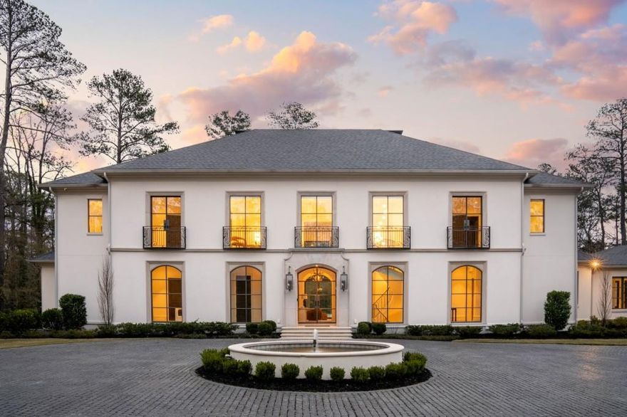 Welcome to an unparalleled living experience at this breathtaking European-inspired estate, perfectly positioned on 2+/- private acres. This exquisite custom designed residence by Harrison is the epitome of luxury, where thoughtful architectural design, meticulous craftsmanship, and premium materials come together in perfect harmony. Step into a world of elegance from the moment you enter, with a dramatic floating stairway, bespoke millwork, and iron windows that invite an abundance of natural light into every room. The wide plank oak flooring adds warmth and character, creating an inviting ambiance that seamlessly flows throughout the home. Each space is meticulously crafted, with multiple arched openings and custom lighting enhancing the luxurious yet functional design. Designed for the ultimate entertainer, the open-concept great room is a true showpiece, anchored by a floor-to-ceiling wall of iron windows that create a stunning connection to the outdoors. Enjoy the tranquil beauty of the expansive turfed backyard, featuring a heated saltwater pool, spa, sun deck, and a covered fireside entertainment space perfect for year-round enjoyment. The heart of this home is the chef-inspired kitchen, boasting a striking 10-foot granite waterfall island, top-of-the-line appliances, and a hidden walk-in pantry. Accordion windows open up to the covered outdoor space, bringing the outdoors in and making al fresco dining a breeze. Retreat to the luxurious primary suite, designed to be a sanctuary of relaxation. A cozy bay window sitting area, two walk-in closets, and a spa-like marble-clad master bath with heated floors, a walk-in steam shower, soaking tub, and twin floating vanities create the perfect environment for unwinding. For family, guests or live-in help, a separate residence was thoughtfully curated with a private entrance that offers a luxurious retreat exemplifying the finest of details, complete with views of the pool and an elevator. A spacious 4-car garage, a state-of-the-art Savant home automation system, and electronic shades throughout both homes elevate the modern living experience. The finished terrace level provides endless possibilities, including a massive recreation room, workout space, and ample room for expansion, with the potential to add a theater, wine cellar, or additional bedrooms. Ample space for a basketball, pickle ball or tennis court. This estate is more than just a home - it's a lifestyle, offering unmatched elegance, privacy, and luxury. Experience the very best of Atlanta living in this one-of-a-kind residence.