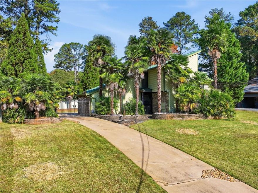 Discover the potential in this spacious 1970s home, located in the Stonemont neighborhood within the Brookwood High School district. While certainly livable as it is, this home offers an excellent opportunity for buyers looking to update and make it their own.

The main level features a tile-floor living room with a gas fireplace, high ceilings, giving the space an open and welcoming feel.  The kitchen offers updated stainless steel appliances and granite counter tops.  A over sized laundry room provides extra storage and would work well as a home office, craft room, or flex space. 

Upstairs, you'll find three generously sized bedrooms for a home of this age with well-maintained hardwood floors. Although the age of the windows is unknown, they are relatively new.

Through the gated driveway you'll find ample parking space. The rear facing garage has been thoughtfully converted into a heated and cooled bonus living area—ideal as a man cave, gym, media room, playroom, or guest hangout. Step directly from this space into the large, private backyard, fully enclosed with a solid wall/fence for added seclusion and privacy. Enjoy the in-ground pool with diving board and covered seating area—perfect for outdoor entertaining and summer fun.  

This home is clean, fun, and full of possibilities. Whether you're looking for a property you can update over time or envision a full transformation, the open concept floor plan unbeatable location make this a rare find.