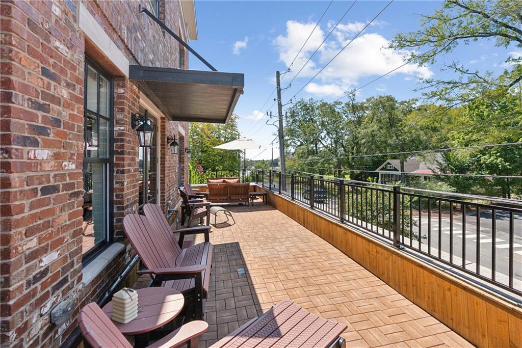 Welcome to your Downtown Woodstock dream home! This exceptional luxury townhome offers 3,454 square feet of beautifully designed space across three levels, with 4 spacious bedrooms and 4 full bathrooms. Every inch of this residence has been thoughtfully crafted for comfort, style, and convenience.
Step inside from the private alley into your sealed-floor garage, complete with a Tesla EV charging station and private elevator access to all levels of the home. Inside, you’ll find soaring ceilings, expansive windows that flood the space with natural light, and premium finishes throughout.
The chef’s kitchen is the heart of the home, featuring solid surface countertops, high-end cabinetry, and an open-concept layout that flows seamlessly into the main living and dining areas. A built-in wine bar adds a sophisticated touch, perfect for entertaining or a relaxing evening at home. The living room is anchored by a sleek tiled fireplace with an adjustable TV mount above the mantle, combining modern design with cozy ambiance.
From the living room, step out onto your expansive 40-foot-wide private deck, spanning the full length of the home — a rare outdoor space ideal for relaxing, dining al fresco, or enjoying the energy of Downtown Woodstock below.
Each bedroom is generously sized and thoughtfully appointed with custom California Closets, providing elegant and functional storage solutions. Additional highlights include a large pantry, multiple utility areas, abundant storage throughout, and refined finishes that elevate every space.
Located in the heart of vibrant Downtown Woodstock, this home places you within walking distance to everything the community has to offer. Just a 6-minute walk to the amphitheater, where you can enjoy a lively summer concert series, and only 10 minutes on foot to over 30 restaurants, wine tasting rooms, craft breweries, boutique shops, entertainment venues, and more.
Directly across the street, Adair Park serves as a social and cultural hub, hosting community favorites like Wine Down Wednesday and Trivia Thursday. Just around the corner, the Woodstock Arts campus features a gallery, black box theater, and outdoor event green with year-round performances and exhibits. You'll also enjoy access to the seasonal farmers market, artisan fairs, and frequent festivals that make downtown living exciting and community-driven.
This golf-cart-friendly neighborhood makes it easy to explore the area, whether you're heading to dinner, a concert, or simply enjoying a ride through the scenic streets. Outdoor enthusiasts will love nearby Rope Mill Park with wooded trails, mountain biking, and river access for kayaking and paddleboarding. For additional shopping, The Outlet Shoppes at Atlanta are just a short drive away, offering premium brands and retail options.
This is more than just a home — it's a lifestyle. A rare opportunity to own a low-maintenance, high-style residence in one of Georgia’s most desirable and walkable downtowns. Luxury, community, creativity, and convenience come together in one extraordinary place. This is a live/work townhome with a bottom portion dedicated to a commercial business. All street parking on Main Street, Linton Street, and Adair Park are unrestricted and available for homeowners and guests in addition to the 2 car garage.
Schedule your private showing today and experience Downtown Woodstock living at its finest!
