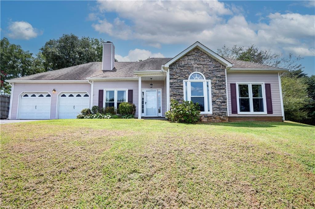 REGAL RANCHER IN INDIAN HILLS WITH PICTURESQUE OUTDOOR OASIS! Experience ONE-LEVEL LIVING in this charming abode, nestled in Rydal in the Blue Ridge Mountains foothills, and perfectly positioned hillside upon its spacious lot. The exterior is adorned with LOW-MAINTENANCE vinyl siding, with handsome, faux stone accents gracing the facade. Step inside the front entry to be welcomed into the LIVING ROOM, with romantic FIREPLACE as the focal point - the perfect space for snuggling in with a pumpkin spice mocha on those crisp, Autumn evenings. The EAT-IN KITCHEN is adorned with alabaster cabinetry, STAINLESS APPLIANCES (including stove/oven, microwave, dishwasher, and REFRIGERATOR), and striking SUBWAY TILE, and also houses the laundry facilities. 2-CAR GARAGE opens to the kitchen for convenient grocery unloading, and also houses a handy storage closet. A FORMAL DINING ROOM is also in place for more elegant meals, and would also make a great HOME OFFICE. The LARGE AND LUXURIOUS OWNER’S SUITE opens to a PRIVATE ENSUITE BATH, complete with DOUBLE VANITIES, JETTED TUB, SEPARATE SHOWER with glass door, WATER CLOSET, and spacious WALK-IN WARDROBE. The secondary bedrooms are generously sized, and share a hall bath with tub/shower combo, which is conveniently positioned for guest use. Enjoy FALL COOKOUTS in the privacy of the FENCED-IN BACKYARD. The spacious patio is accessed from the kitchen, and provides a vivacious venue for al fresco dining. Handsome stone steps lead the way to the IN-GROUND POOL, which features a DIVING BOARD, SLIDE, and is operated with a chlorine system. This is a fabulous space for ENTERTAINING and enjoying Fall festivities. The PUMP HOUSE keeps the elements protected, and provides room for the storage of pool supplies. Also on the property is an OUTBUILDING with additional LEAN-TO STORAGE, and a FIREPIT to enjoy with friends. Convenient to I-75, Cartersville, Waleska, Canton, Calhoun, and Fairmount with local attractions, shopping, dining, and more all within easy reach. NO HOA FEES! Don’t miss the opportunity to call 22 Indian Hills Drive HOME.