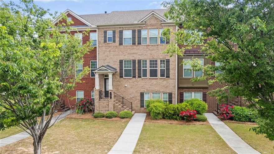 MOVE IN READY!  LOCATION! LOCATION! just minutes away from GA-400, Avalon, Halcyon, and the vibrant Downtown Alpharetta area. Welcome to your dream home, 3 bedrooms, 3 full baths, and a half bath Brick Townhome in coveted Deerfield Green! Step inside to discover a bright dining space adorned with a chic chandelier, ideal for entertaining. The gourmet kitchen impresses with granite countertops, and stainless steel appliances, effortlessly connecting to a spacious living area featuring built-ins and a cozy fireplace. Large deck is ideal for entertaining and grilling! Upstairs, the oversized master suite awaits, complete with a tray ceiling, walk-in closet with custom shelving, and a luxurious ensuite bath featuring a double vanity, a soaking tub, and a separate shower. An additional bedroom with a private ensuite bath is located on this level, along with a laundry room for added convenience. The finished lower level features a private bedroom and full bath providing a flexible space that can serve as a guest suite, teen retreat, or home office. This townhome’s community amenities include a pool, playground, sidewalks, Two Car Garage and ample guest parking, ensuring an enriched lifestyle. Located in Top-rated schools! Near shopping, groceries, dining, coffee houses and entertainment options, this home embodies comfort and convenience.