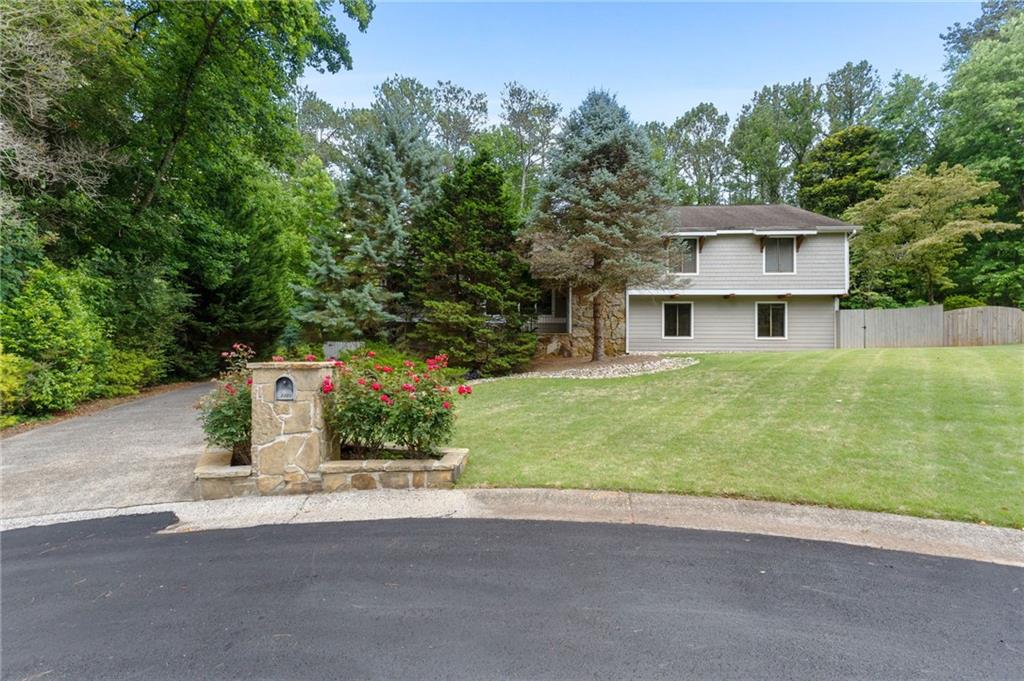 Now available for your consideration, this fabulous architectural gem located in beautiful East Cobb offers four bedrooms, three full baths, separate dining room, and so much living space for your family to enjoy. The generously sized living room is complimented by a gorgeous beamed and vaulted wood ceiling, stone fireplace and beautiful views of the front and back yard through no shortage of windows. The recently updated kitchen includes stainless steel appliances, wall microwave and oven, ceiling height custom cabinets with slide out drawers, pantry, and extra storage in the island. Enjoy a morning cup of coffee or relax with an evening cocktail on the screen porch overlooking the beautifully landscaped private back yard. Back yard is fully fenced for kids and pets to enjoy. Upstairs you will find the master bedroom with its own private balcony, walk-in closet, and bathroom with soaking tub and separate shower as well as two secondary bedrooms and another full bath. On the lower level there is an additional bedroom with walk out access to the deck, another full bath, and large bonus area that could be used for a rec room, second living space, home office - the possibilities are endless here. An enormous two car garage offers not only room for both vehicles but lots of extra space for storage, workbenches, etc. Don't miss the bonus area (currently used as a gym) at the far end of the garage! In addition to the two car garage, the driveway extends into the back yard for additional parking perfect for guests, boat, or RV parking. There is no mandatory HOA however residents can join Weatherstone Swim and Racquet Club to take advantage of the pool and other amenities if you choose for an additional fee.