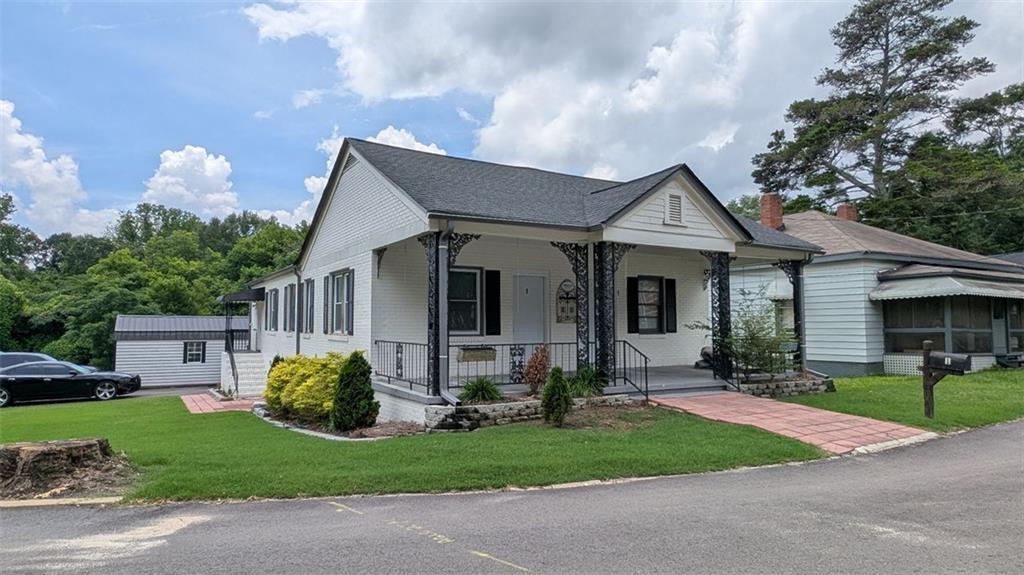 Welcome to this beautifully renovated four-sided brick ranch that offers the perfect blend of classic charm and modern updates. From the moment you arrive, you’ll be captivated by the home’s striking curb appeal, manicured landscaping, and inviting front yard.
Inside, high ceilings and elegant hardwood floors create a warm, open feel throughout. The updated kitchen and bathrooms feature stylish finishes designed for both comfort and sophistication. Modern light fixtures enhance the contemporary aesthetic, while maintaining the cozy atmosphere of this thoughtfully upgraded home.
Step out back and discover a fully fenced backyard oasis, complete with professional hardscaping, a wooden deck, and an oversized metal gazebo—ideal for outdoor entertaining or simply relaxing in a peaceful setting. A spacious covered front porch and a rare large driveway (a true gem in Porterdale) add both convenience and charm.
Need extra space? The property includes a generous storage building, providing endless possibilities for hobbies, tools, or additional storage.
Located in the heart of Porterdale, this home offers the best of small-town living with easy access to I-20—just minutes away for a seamless commute. Enjoy the tranquility of a close-knit community while staying connected to everything you need.
Don’t miss your opportunity to own this move-in-ready gem—schedule your private showing today!