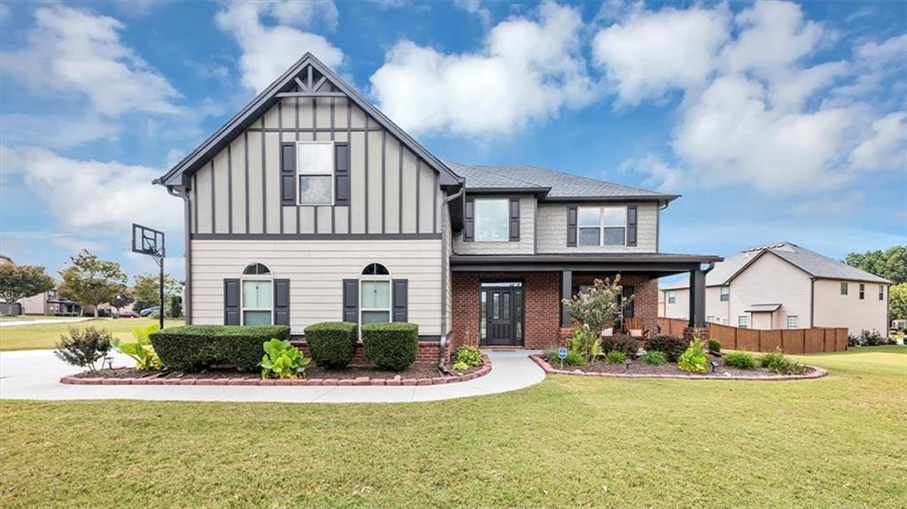 Come sit in the rocking chairs on the front porch or relax on the back extended deck of this stunning European Traditional home in the Grayson District!!! Step inside this 2-story foyer home featuring hardwood floors on the entire main level, crown molding and architectural arches. The kitchen features a ton of stained cabinets with a double oven and eat in kitchen area with a bay window and overlooks the family room with the cozy stone fireplace. The dining room is stunning with coffered ceilings and chair rail molding. The large master bedroom and bathroom are amazing. The master shower with new porcelain tile and new frameless glass was replaced in 2024. Beautiful community, sidewalks, LED street lights, Playground and Pavilion area. Professionally landscaped (park like) yard with new sod on one side, newly planted crape myrtles and large private fenced backyard. The extended driveway and patio was added in 2023. Remote control blinds for upstairs foyer window and ceiling fans in all rooms. Smart home with remote thermostat, security system, ring camera over garage, front door keypad and doorbell camera. Agent-owner.