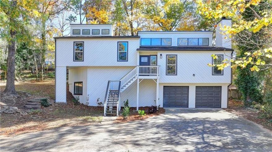 Here is your chance to move into a spacious, updated, contemporary home in Pope HS district! All the heavy lifting has been done, and all that is needed is you!  This home has been updated with new roof, new windows on the exterior. Upon entry you will notice the newly installed  gleaming hardwood floors throughout. The spacious living room is anchored by a cozy fireplace. Accent walls bring interest and elevate the space. There is plenty of space to entertain for the holidays in the dining room and adjacent kitchen. The kitchen will delight any chef with its new stainless steel appliance package and a GAS range! A three-season sunroom is located off the dining room. Upstairs features 2 secondary bedrooms which share the hall bath. The bath has been updated with a custom tiled tub/shower combo, new vanity, and lighting. The primary bedroom is spacious and features a luxurious bath featuring a tiled shower with a frameless glass door and dual vanity. The terrace level has a bedroom and a tiled bathroom. A bonus room can be a media room/playroom/ or office space. All of this AND located in  top-ranked Murdock/Dodgen/Pope HS school district. New deck is off the dining room and gives you the outdoor living space for your outdoor entertaining. EAST COBB SWIM AND TENNIS can be joined if you are looking for swim/tennis close by. Restaurants, shopping, major road access is all near. Quick trip to Downtown Roswell. Your buyers will love this home.